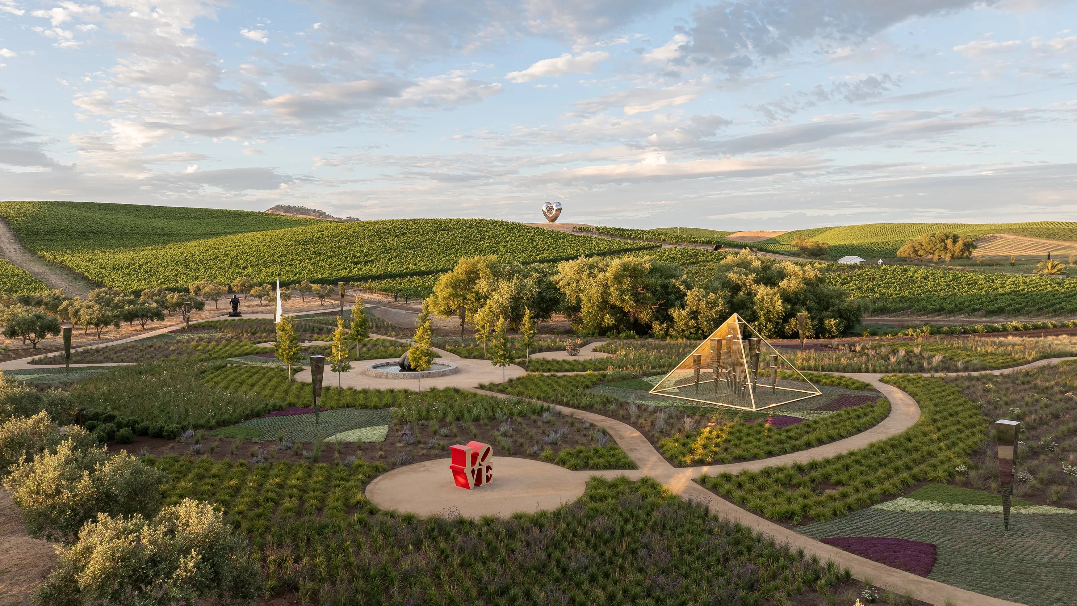 A landscaped sensory garden with grasses, shrubs, and sculptural stones at the Donum Estate